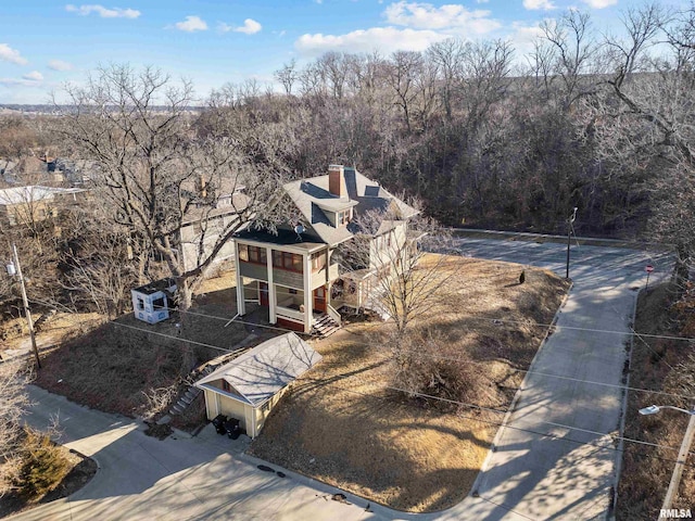 bird's eye view with a wooded view