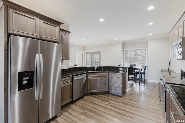 1621 S Eugene Ln, Marion, IL 62959 - kitchen with light wood-type flooring, a sink, appliances with stainless steel finishes, a peninsula, and crown molding