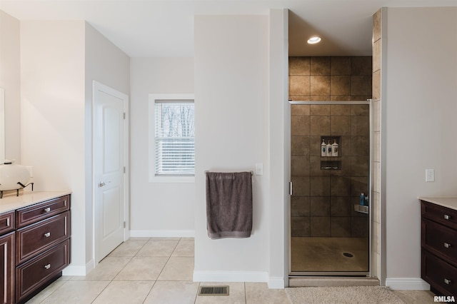 1621 S Eugene Ln, Marion, IL 62959 - bathroom featuring tile patterned floors, visible vents, a stall shower, and vanity