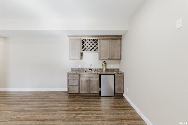 1621 S Eugene Ln, Marion, IL 62959 - bar with a sink, baseboards, dishwasher, wet bar, and dark wood-style flooring