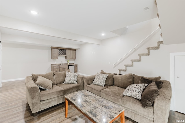 1621 S Eugene Ln, Marion, IL 62959 - living room featuring indoor wet bar, stairway, wood finished floors, and baseboards