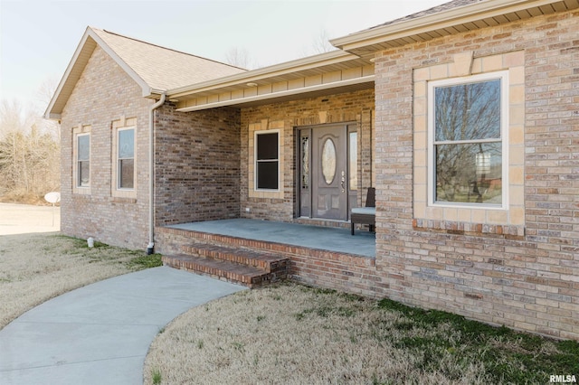 1621 S Eugene Ln, Marion, IL 62959 - doorway to property featuring brick siding, covered porch, and a shingled roof