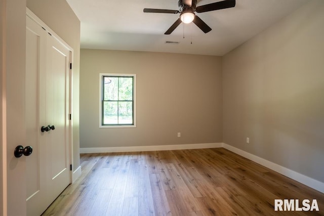 207 Rowatt St, Cambria, IL 62915 - unfurnished bedroom featuring wood finished floors, baseboards, and a ceiling fan
