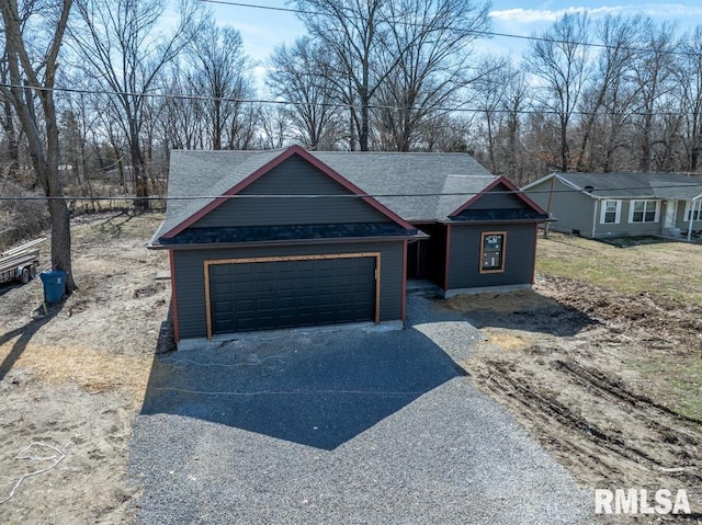 207 Rowatt St, Cambria, IL 62915 - view of front facade with driveway, a shingled roof, and an attached garage