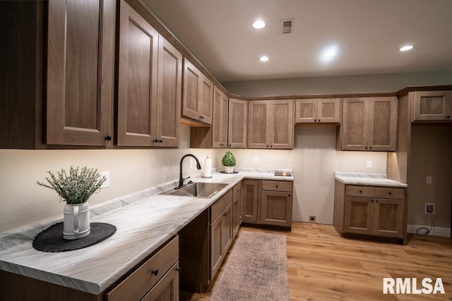 207 Rowatt St, Cambria, IL 62915 - kitchen featuring a sink, light wood finished floors, recessed lighting, and light countertops