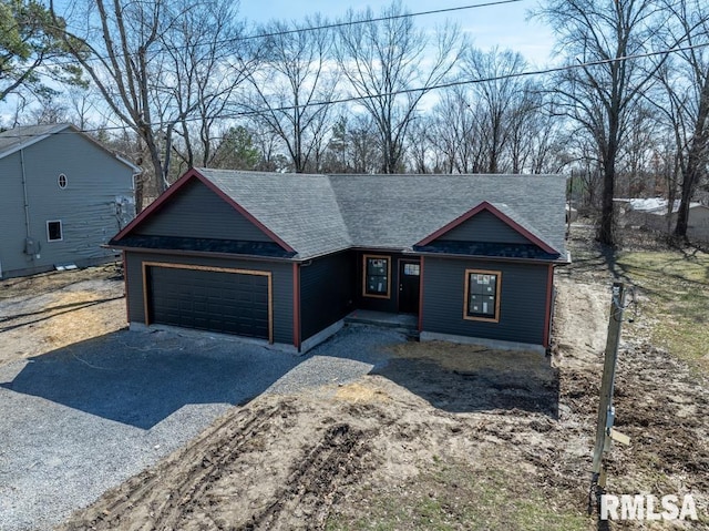 view of front of home with gravel driveway, a garage, and roof with shingles