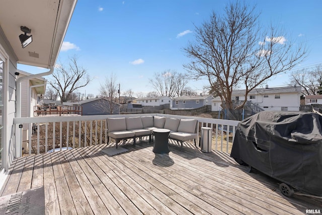 deck with an outdoor living space, a residential view, and a grill