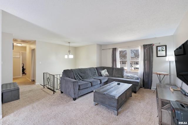 living area with light colored carpet, baseboards, and a textured ceiling