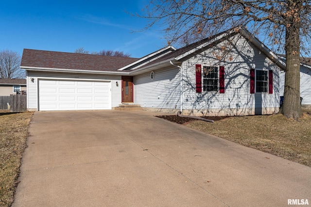 ranch-style house featuring driveway, an attached garage, and fence