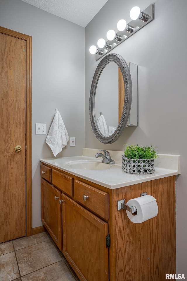 bathroom featuring vanity and a textured ceiling