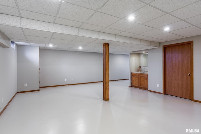 finished basement with recessed lighting, a drop ceiling, and baseboards