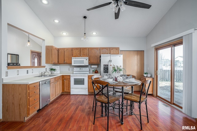 kitchen featuring appliances with stainless steel finishes, pendant lighting, light countertops, and lofted ceiling