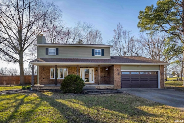 traditional home featuring an attached garage, fence, brick siding, and driveway