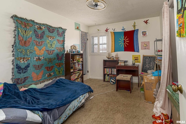 carpeted bedroom with baseboards and a textured ceiling