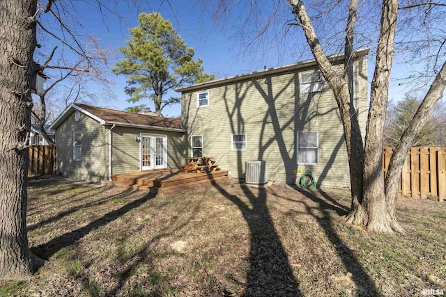 rear view of property with central air condition unit, a deck, and fence