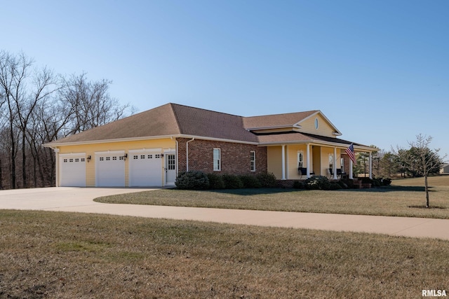 view of front facade with driveway, an attached garage, covered porch, a front lawn, and brick siding