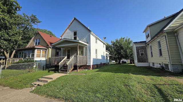 shotgun-style home featuring a front yard and fence