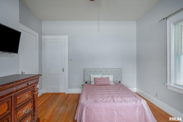 bedroom with light wood-type flooring and baseboards