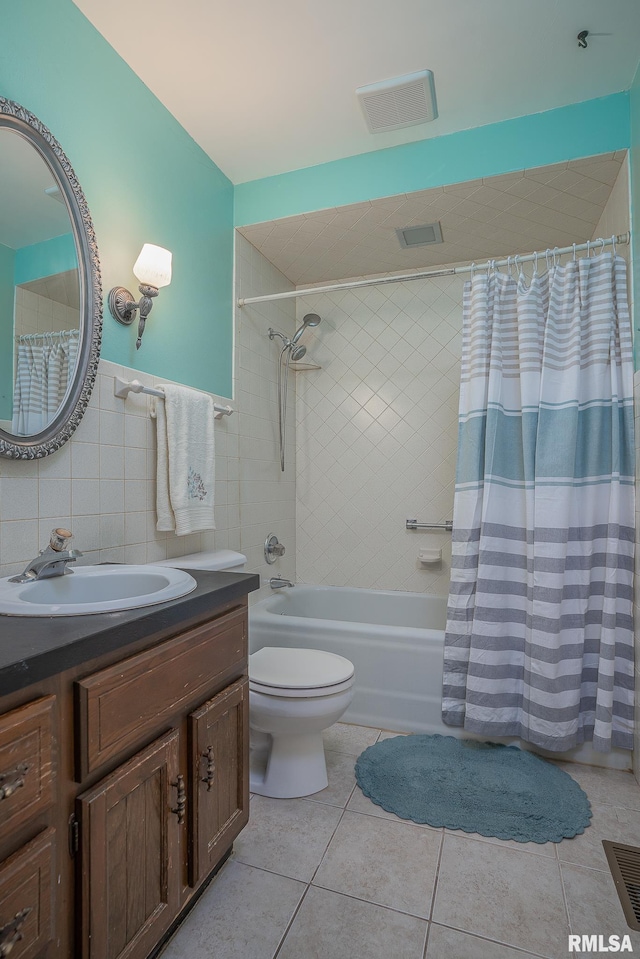 bathroom featuring tile patterned floors, visible vents, vanity, and shower / tub combo