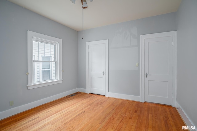 unfurnished bedroom with light wood-style floors and baseboards