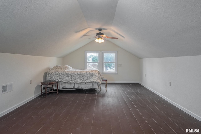 bedroom featuring visible vents, a ceiling fan, a textured ceiling, dark wood-style floors, and lofted ceiling