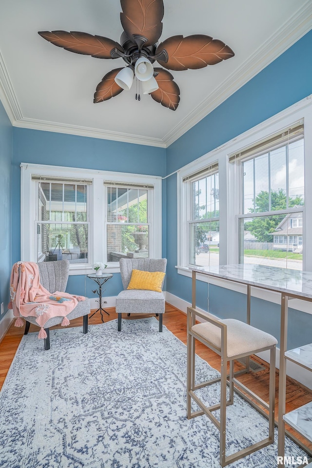 sunroom featuring ceiling fan