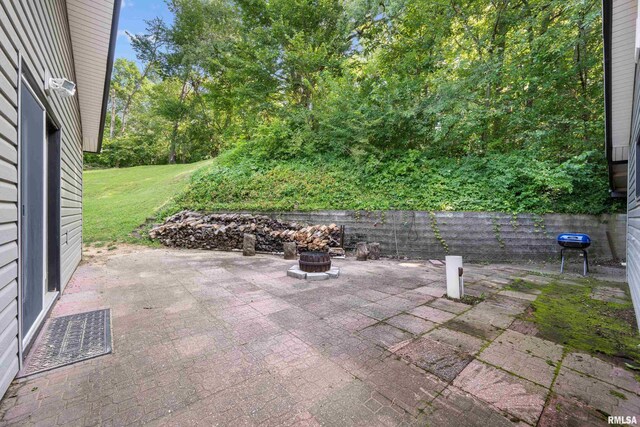 view of patio / terrace featuring an outdoor fire pit