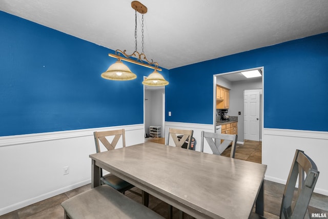 dining area featuring a wainscoted wall