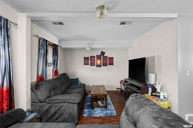 living area featuring visible vents and wood finished floors