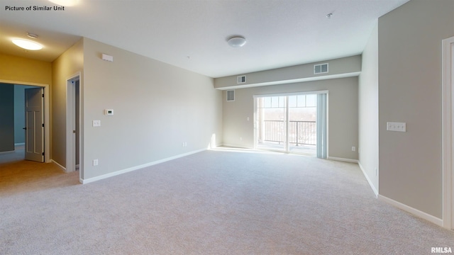 spare room featuring visible vents, baseboards, and carpet