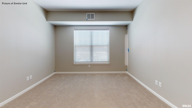 carpeted empty room featuring visible vents and baseboards