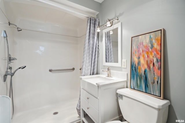 bathroom featuring a shower with shower curtain, toilet, and vanity