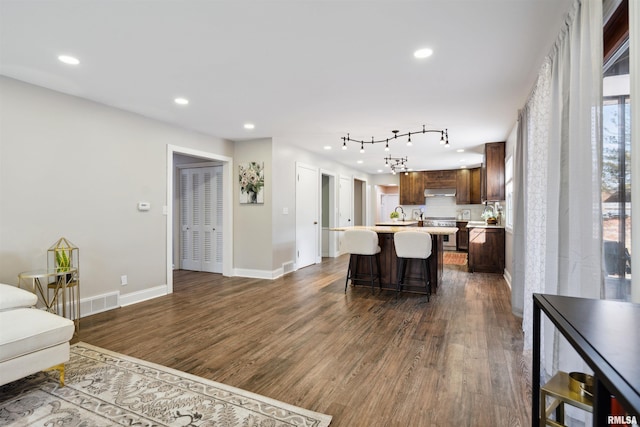 living area with recessed lighting and dark wood-style floors