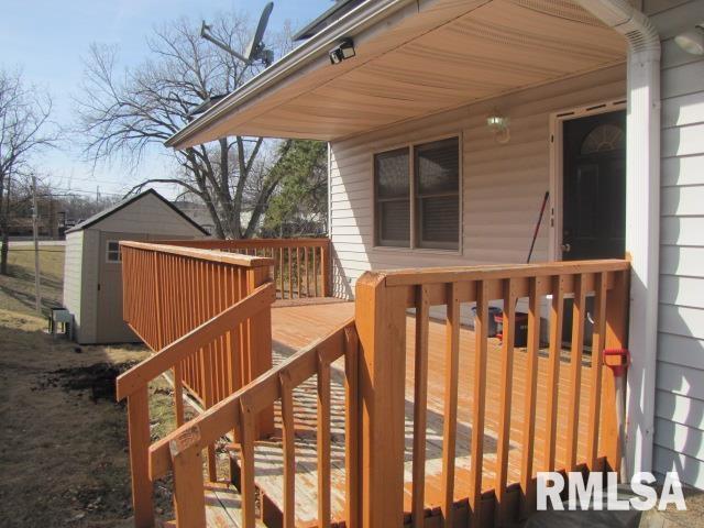 deck featuring a storage shed and an outbuilding