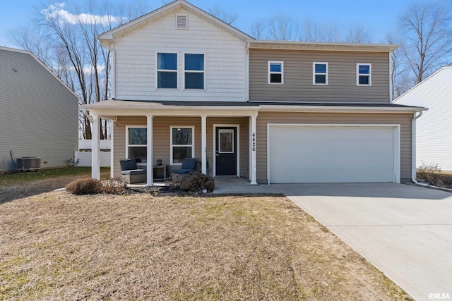 traditional home featuring cooling unit, driveway, a porch, a front lawn, and a garage