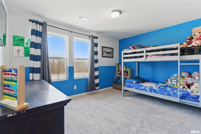 bedroom with carpet flooring, baseboards, visible vents, and a textured ceiling