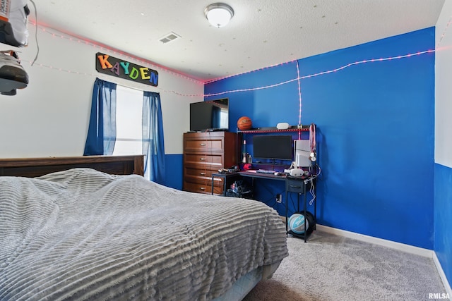 bedroom featuring visible vents, baseboards, and carpet