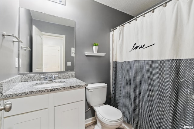 bathroom featuring a textured ceiling, toilet, vanity, and a shower with curtain