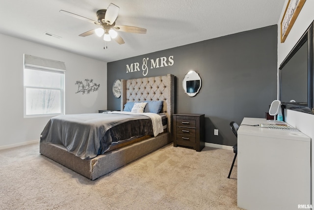 bedroom with visible vents, light carpet, and baseboards