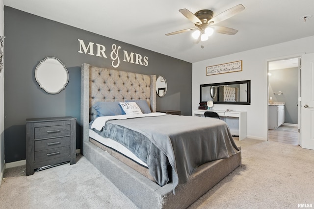 carpeted bedroom featuring connected bathroom, a ceiling fan, and baseboards