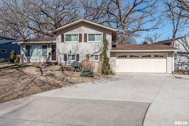 tri-level home with driveway and an attached garage