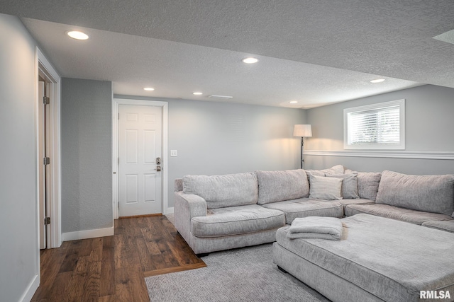 living area with recessed lighting, a textured ceiling, baseboards, and wood finished floors