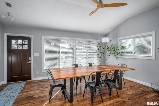 dining space with ceiling fan, baseboards, lofted ceiling, and dark wood-style floors