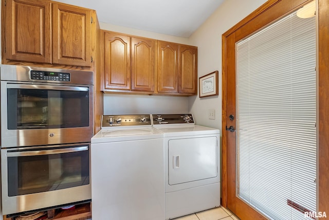 clothes washing area featuring light tile patterned floors, laundry area, and separate washer and dryer