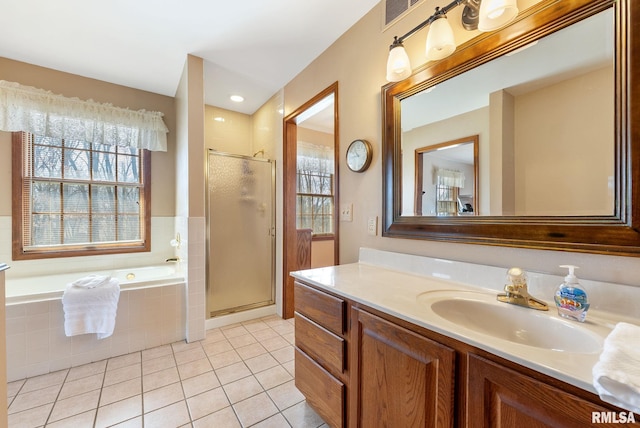 bathroom with vanity, visible vents, a shower stall, a garden tub, and tile patterned floors