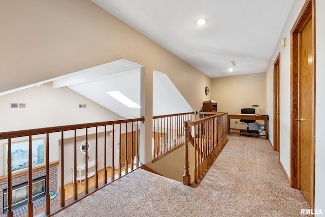 hallway featuring carpet and visible vents