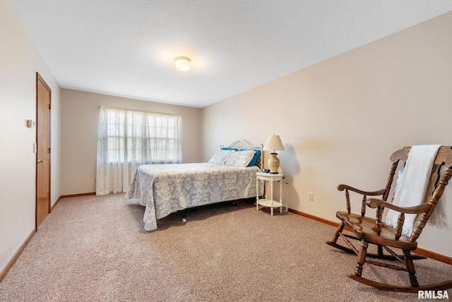 carpeted bedroom featuring baseboards and a textured ceiling