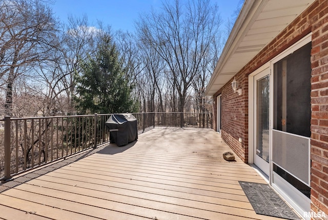 wooden deck featuring a grill