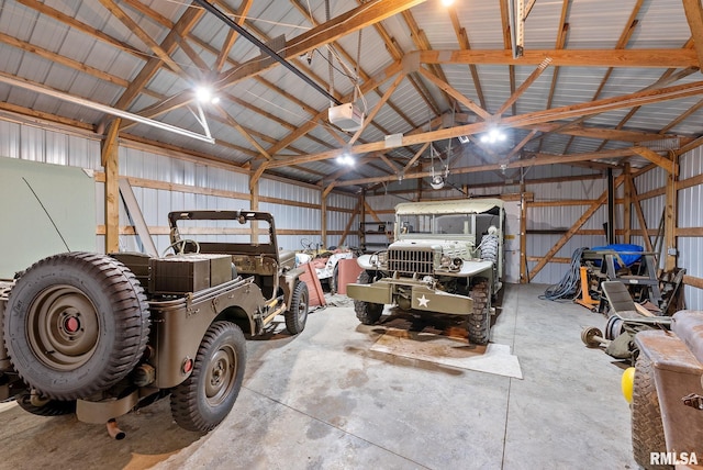 garage with a garage door opener and metal wall