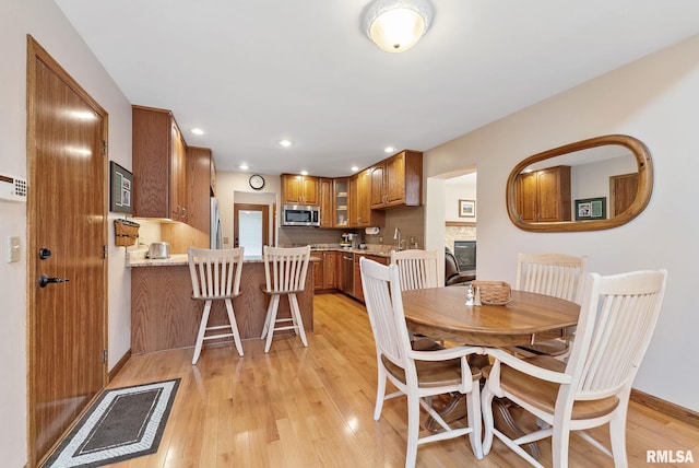 dining room featuring recessed lighting and light wood-type flooring